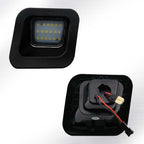 A black square LED light fixture shown from two angles: one facing forward with a grid of yellow LED chips visible, and the other showing the back with internal components, red and black wires, and a gold connector.
