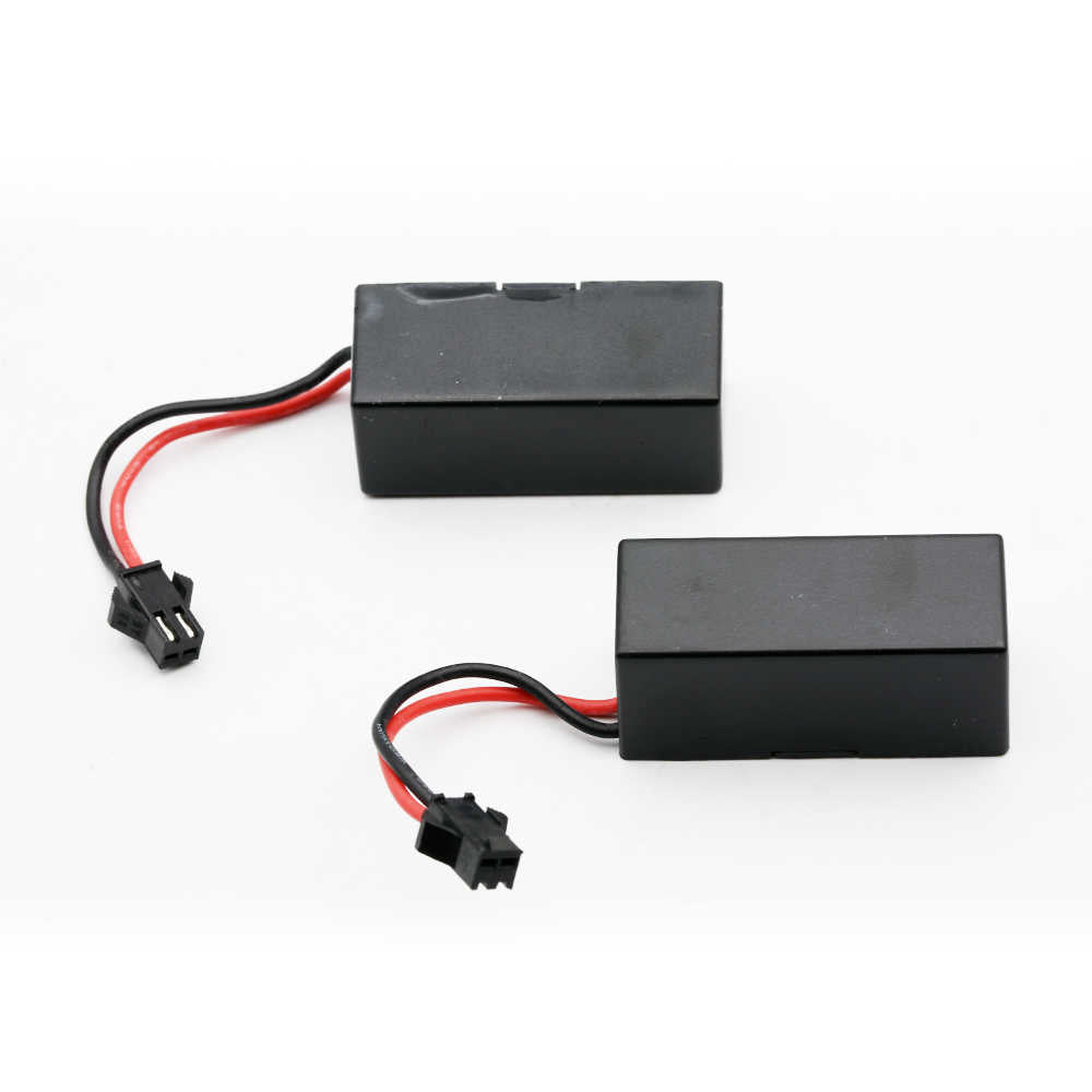 Two black rectangular battery packs with attached red and black wires and connector ends, photographed on a plain white background.