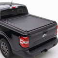 A truck bed cover installed on the bed of a black Ford Maverick pickup truck.