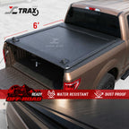 Truck bed with a tonneau cover and JC Trax branding on a white background
