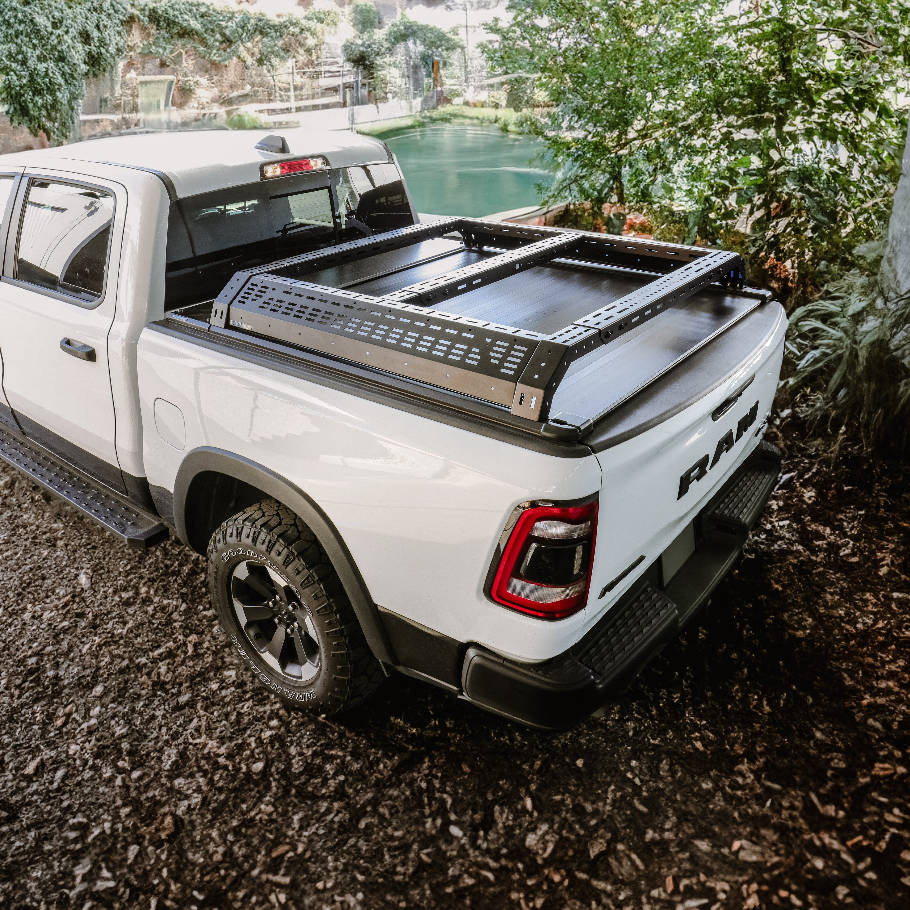 White Ram truck with a black cargo bed cover in a natural setting
