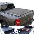 Gray RAM truck with a tonneau cover and an open storage compartment showing tools.