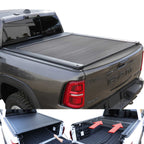 Gray RAM truck with a tonneau cover and an open storage compartment showing tools.
