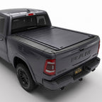 Gray Rambox pickup truck with a retractabel tonneau cover on a white background