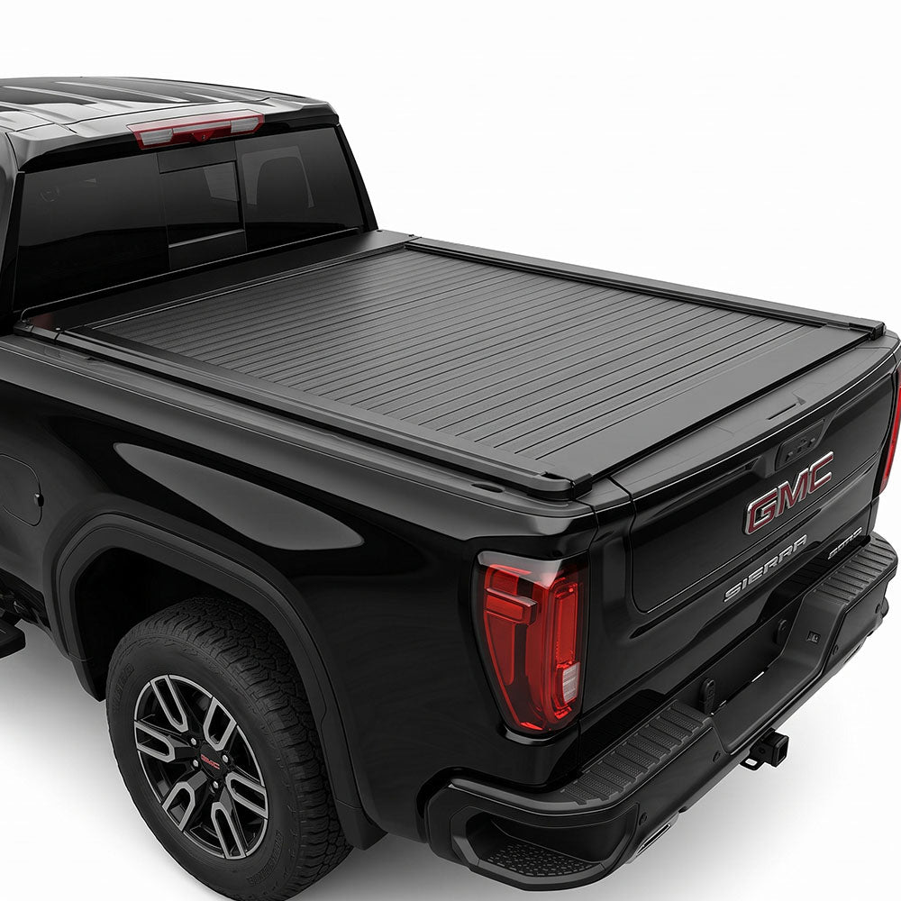 A black truck bed cover installed on the bed of a black GMC Sierra pickup truck.
 
