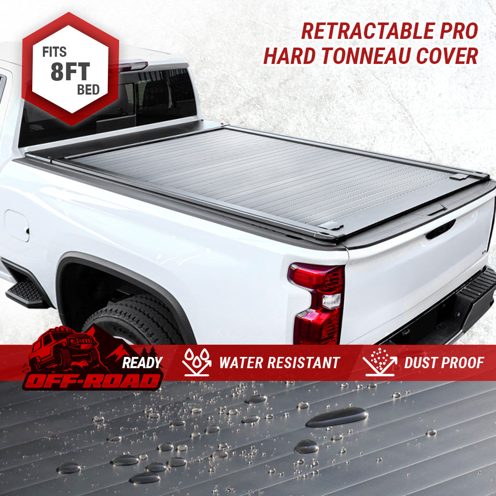 Retractable hard tonneau cover on a white truck bed with branding and product features displayed.