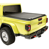 Yellow Jeep truck with a tonneau cover on a white background