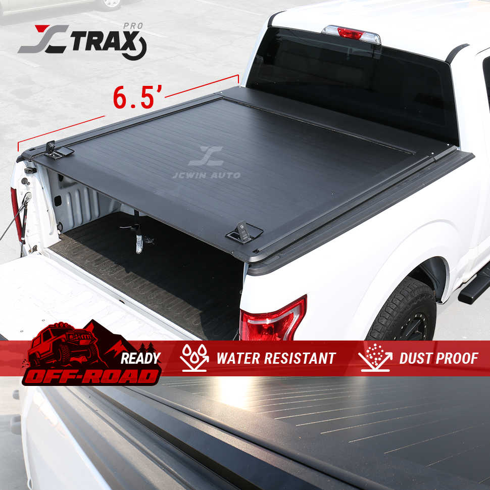 Truck bed cover with JC Trax branding and features on a white truck background