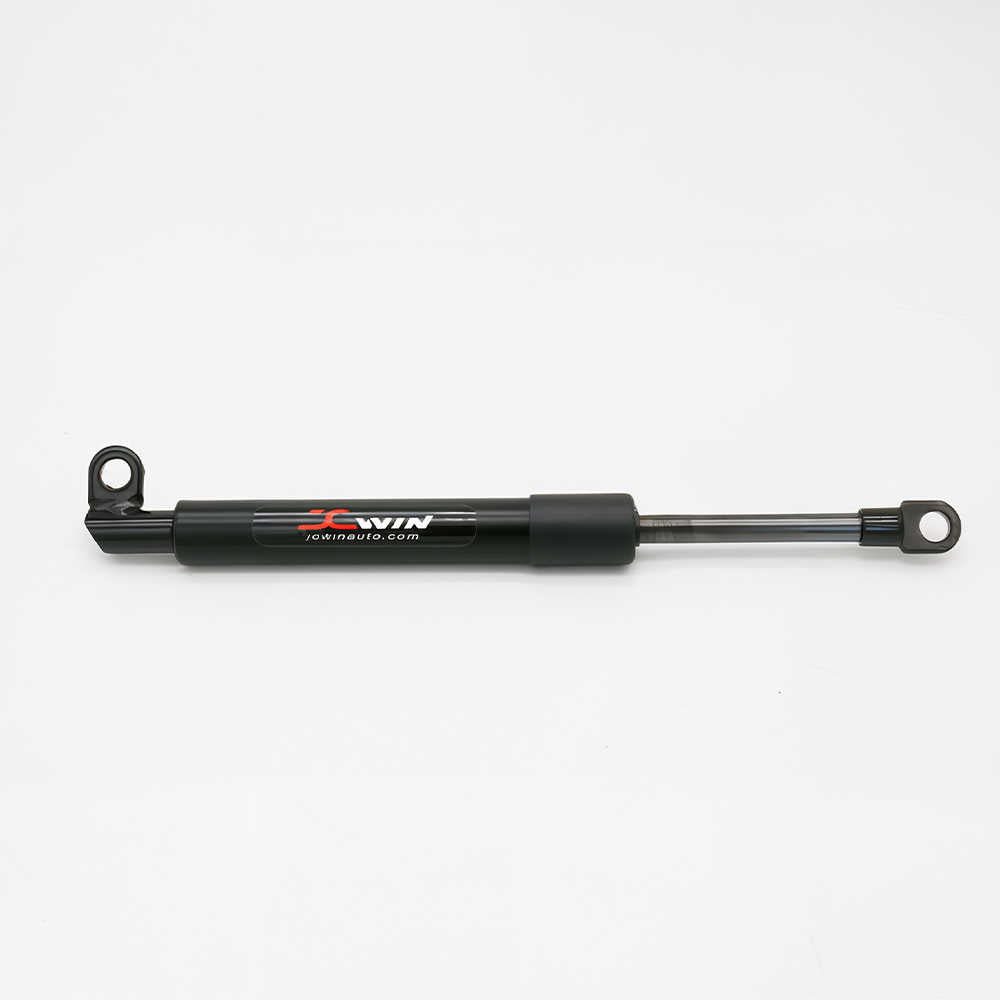 A black hydraulic brake booster cylinder with a silver metal rod and mounting loops, featuring the 'JCWIN jcwinauto.com' logo on the side, photographed on a clean white background.