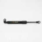 A black hydraulic brake booster cylinder with a silver metal rod and mounting loops, featuring the 'JCWIN jcwinauto.com' logo on the side, photographed on a clean white background.