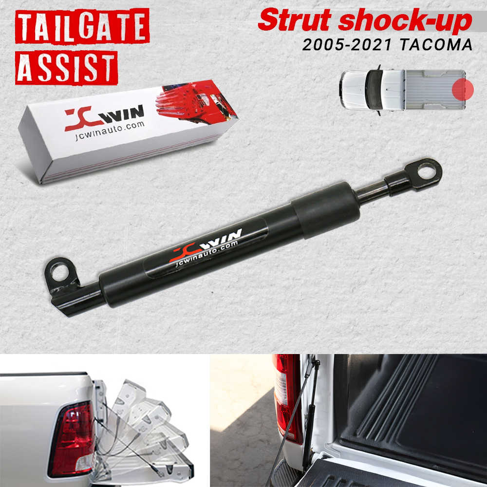 Black Jcwin tailgate assist strut shock absorber for 2005-2020 Tacoma, shown with its retail box, a small vehicle diagram, and inset photos of the product installed on a truck tailgate.