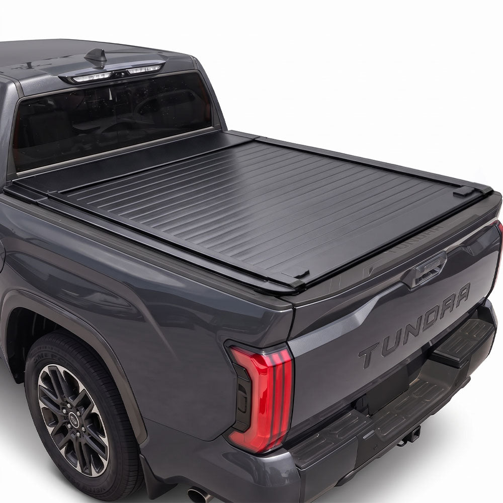 Grey Tundra truck bed installed mb retractable tonneau cover with white background.