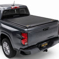 A retractable tonneau cover installed on gray Chevy Colorado
