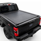 A truck bed cover installed on the bed of a black Ford F-250 Super Duty pickup truck.