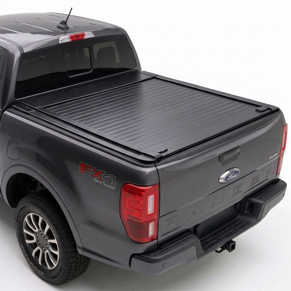 A black retractable truck bed cover installed on the bed of a dark gray Ford Ranger pickup truck.