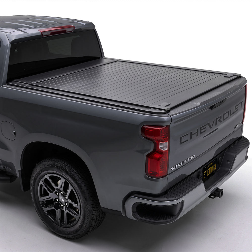 Gray Silverado truck with a tonneau cover on a white background