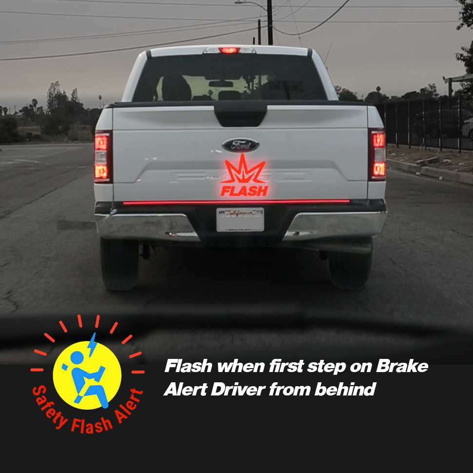 Back of a white truck with a red 'Flash' logo and safety feature description.