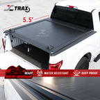 A black retractable tonneau cover on a white truck, highlighting its water resistant and dust proof features.